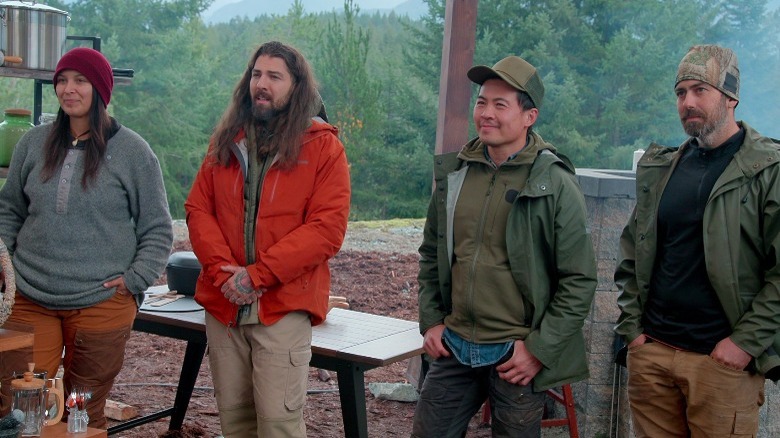 Contestants on Chefs vs. Wild looking off camera