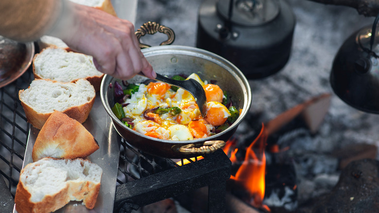 Making eggs over a campfire