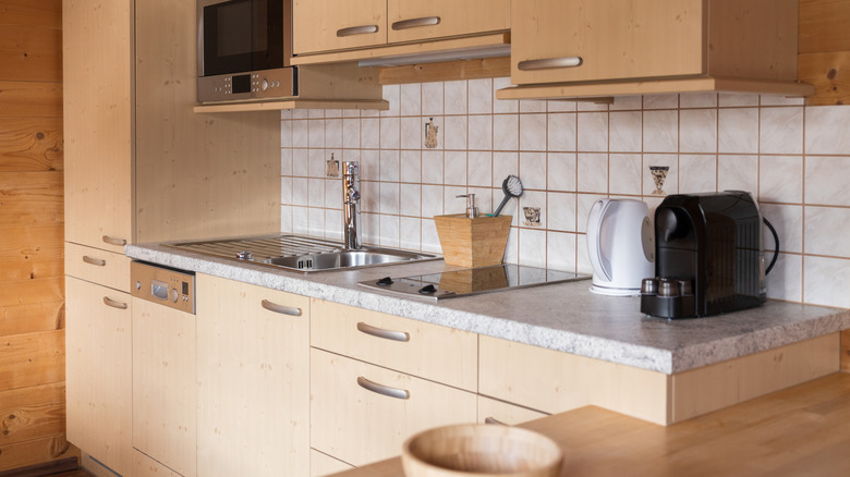 Kitchenette with wood color and white tiles