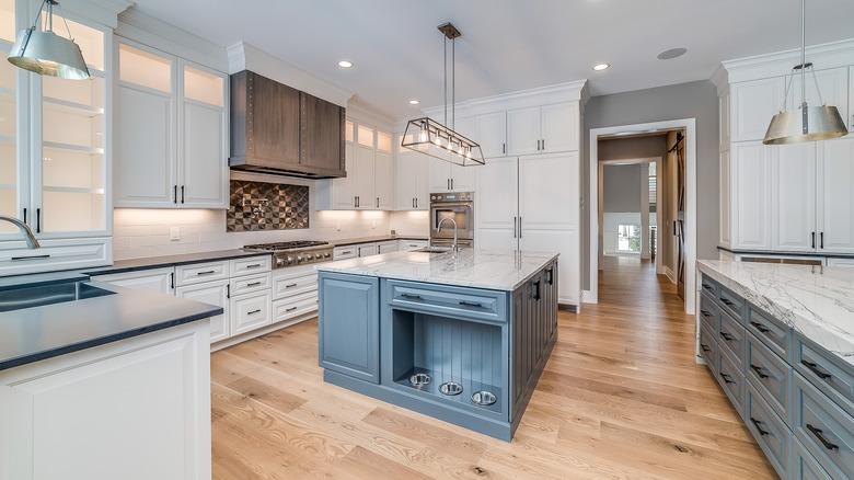 Neutral kitchen with wooded blue island