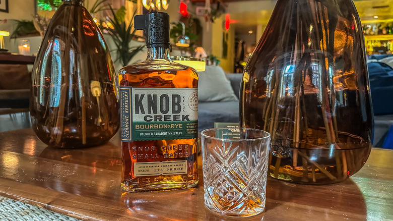 Knob Creek bourbon x rye bottle and glass