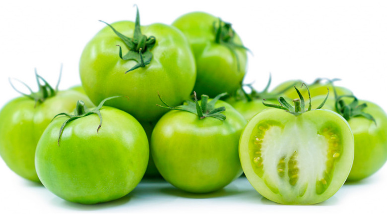 Green tomatoes on white background