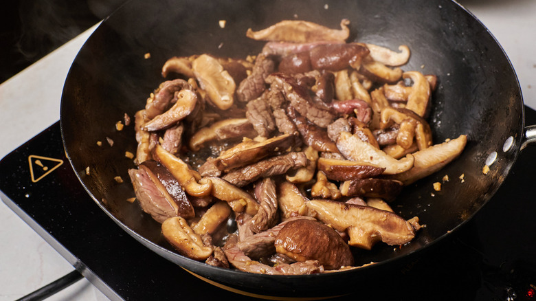 cooking steak and mushrooms