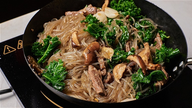 noodles and vegetables in wok