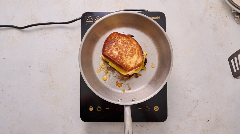 toasting grilled cheese in skillet