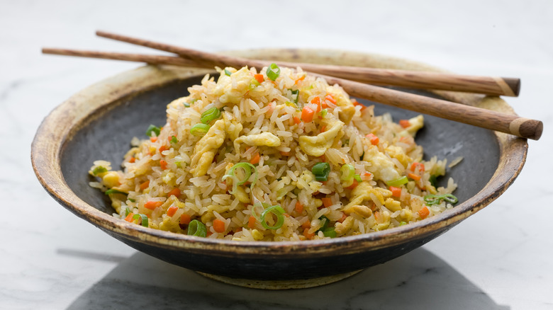 Fried rice in bowl with chopsticks