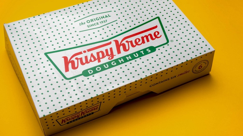 Krispy Kreme doughnut box on a yellow background