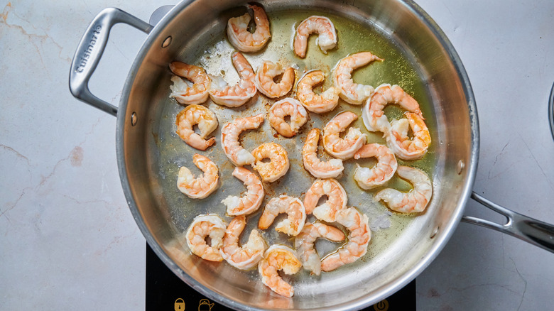 shrimp cooking in oiled pan