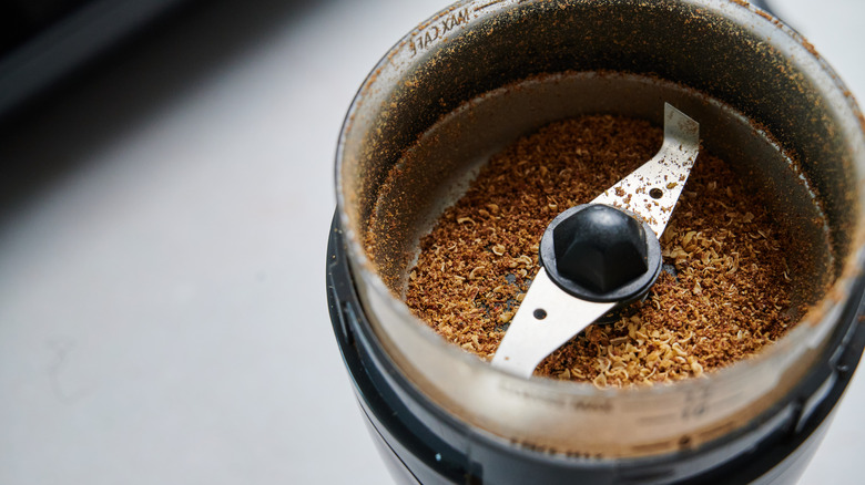 Sichuan peppercorns in spice grinder