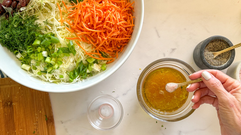 hand adding salt to bowl