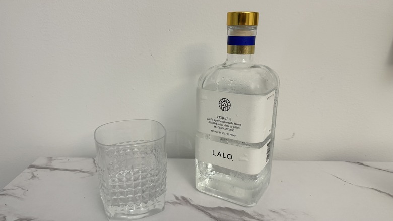 Lalo tequila on right of square glass