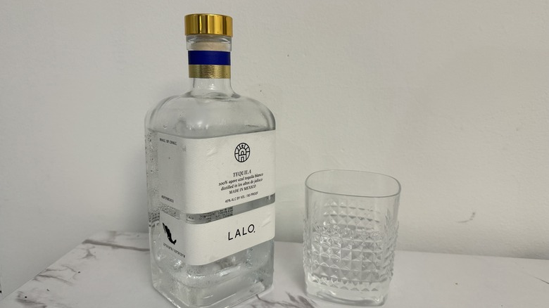 Bottle of Lalo Tequila with a square glass