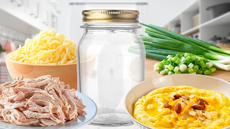 a mason jar surrounded by cheese, grits, scallions and chicken