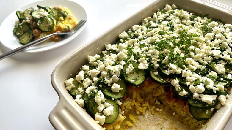 layered zucchini casserole baking dish and plate with a serving of casserole