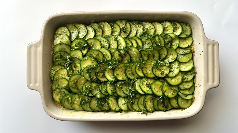 sliced zucchini shingled in a baking dish