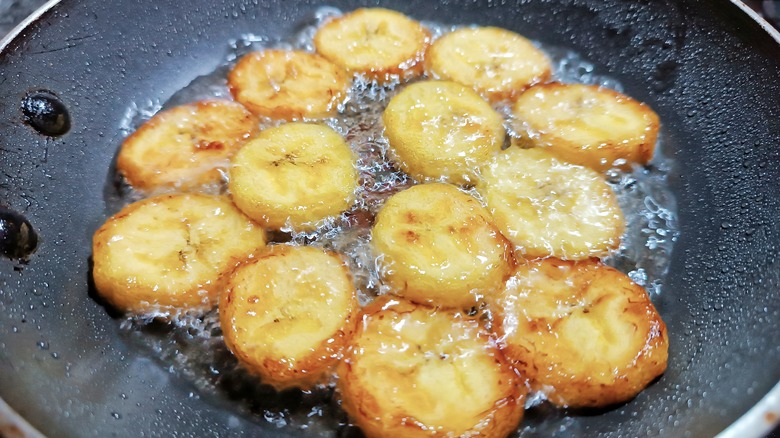 sliced bananas frying in a pan