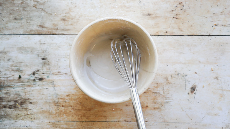 Whisking sugar glaze in bowl