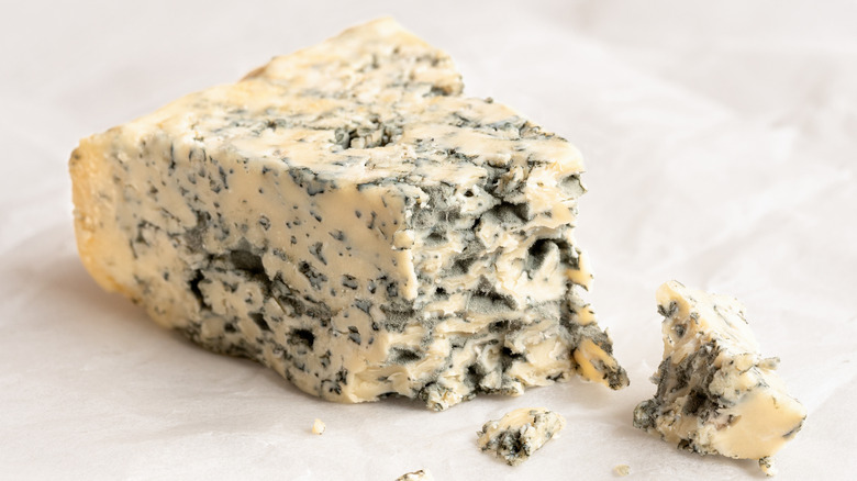 blue cheese with piece broken off