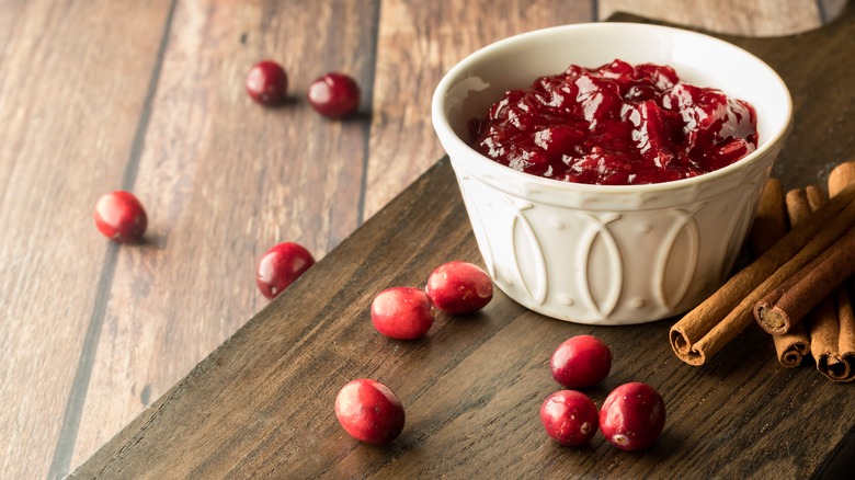 Fresh cranberry sauce against a wooden board