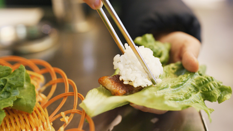 adding rice to lettuce wrap