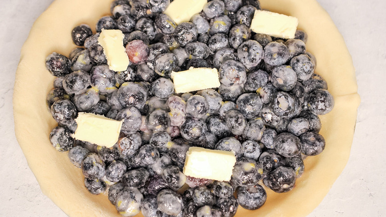 blueberries and butter in pie crust