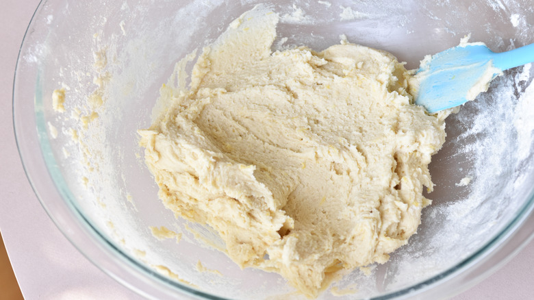 adding flour to batter