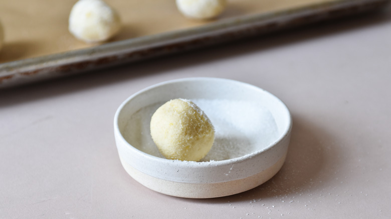 rolling cookie dough in sugar