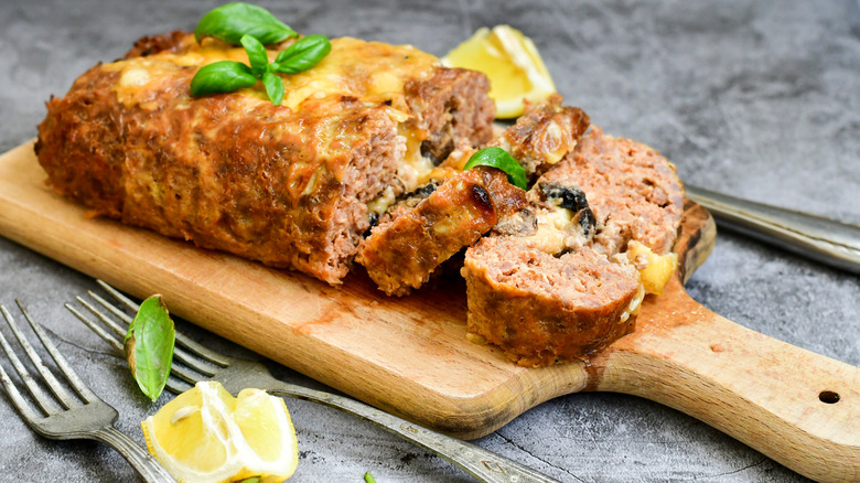 Meatloaf on cutting board with lemon wedge