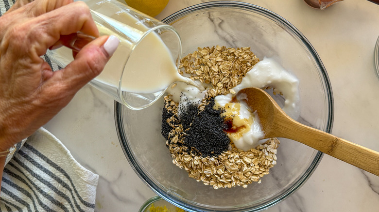 hand pouring milk into bowl