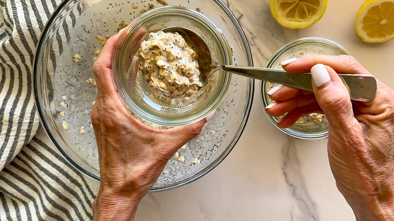 hand spooning mixture into jar