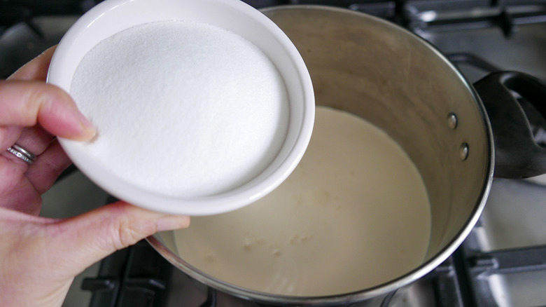 adding sugar to cream