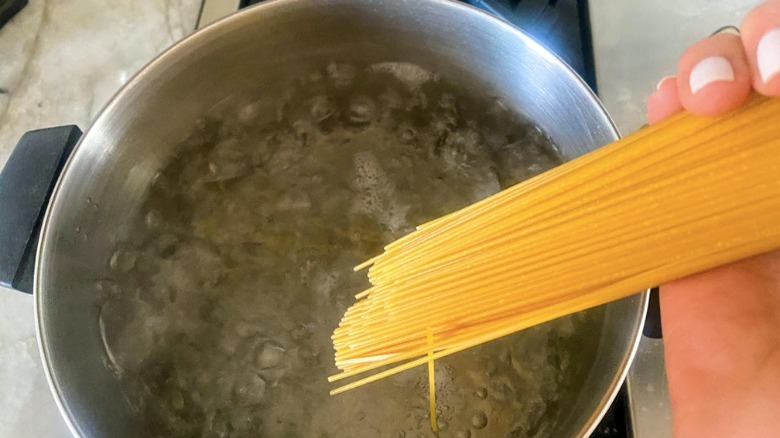 placing pasta in boiling water