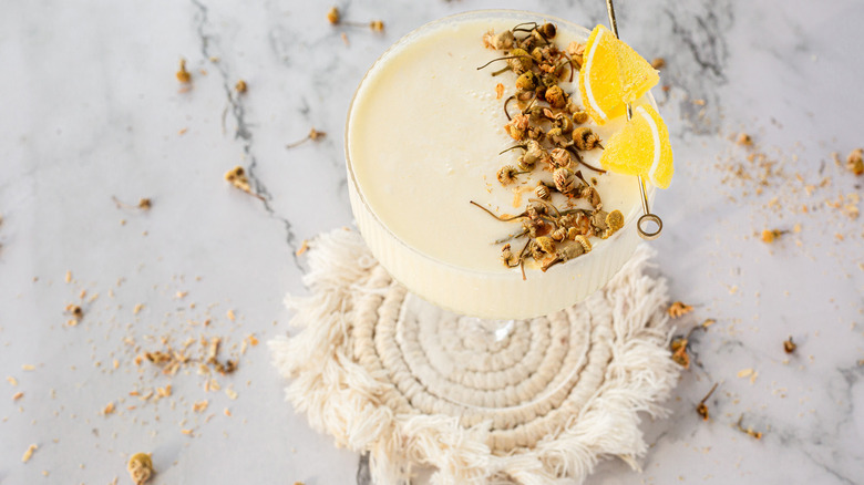 garnished drink with flowers in background