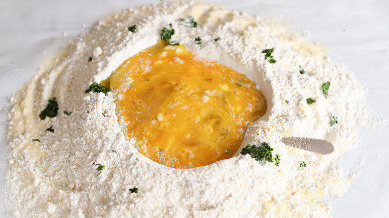 eggs whisked in flour well