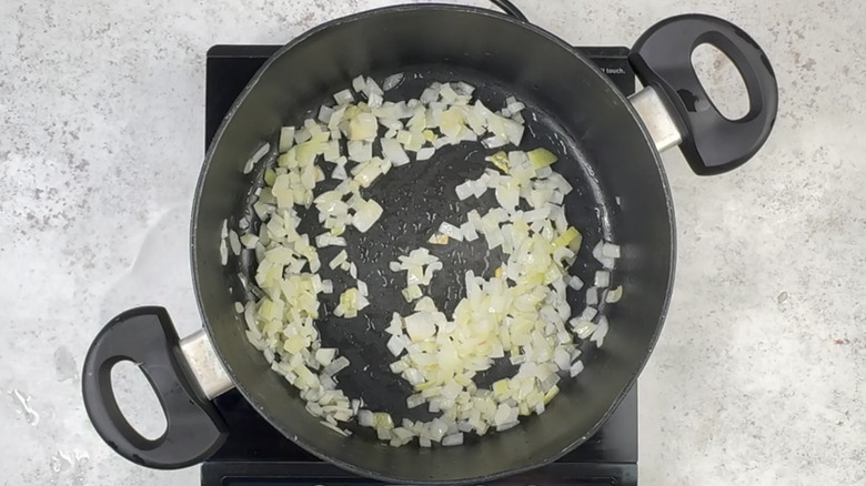 frying onion in pot
