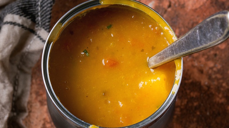 Top-down view of an open tin can of carrot soup