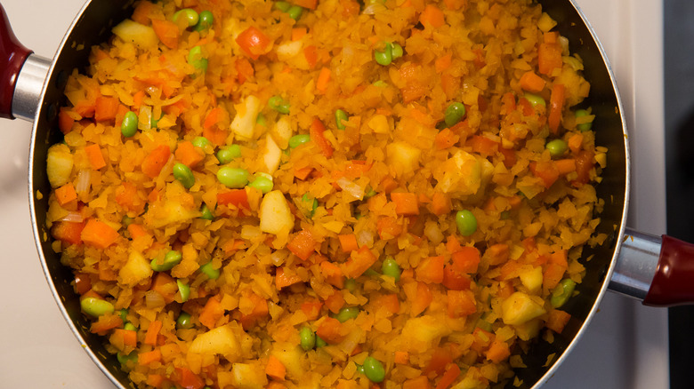 butternut squash rice cooking in pan