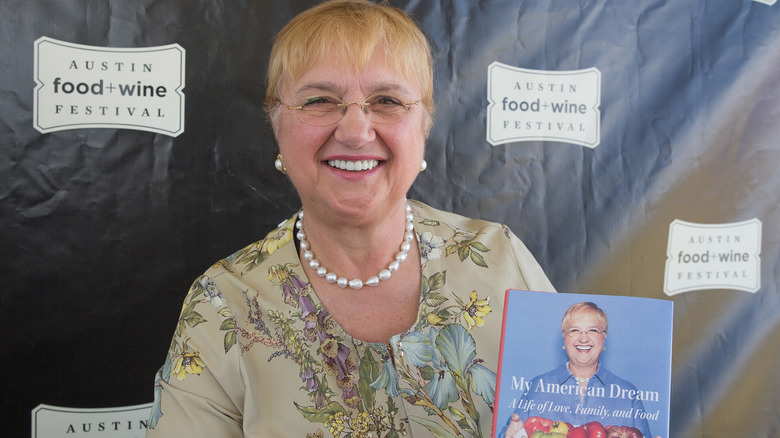 Lidia Bastianich smiling with cookbook