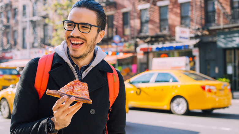 NYC man with pizza slice