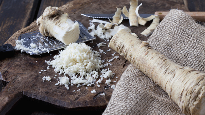 grated horseradish root on wood