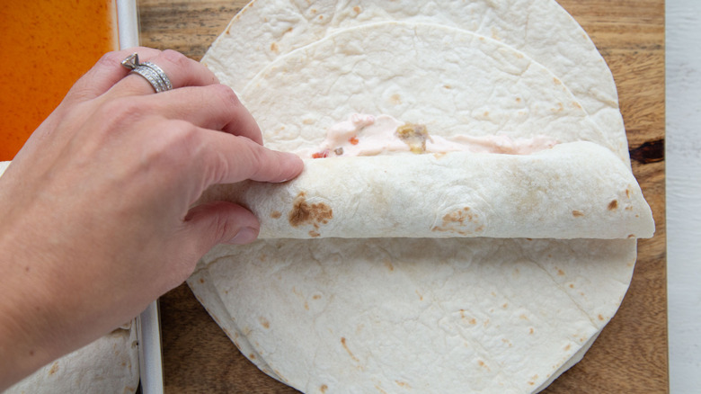 hand rolling tortilla