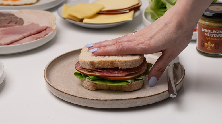 placing bread slice on sandwich