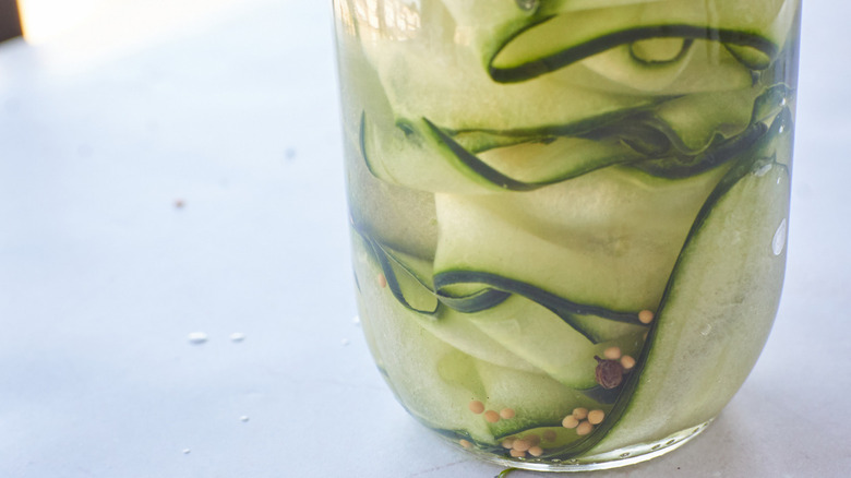 thin-sliced cucumbers in jar