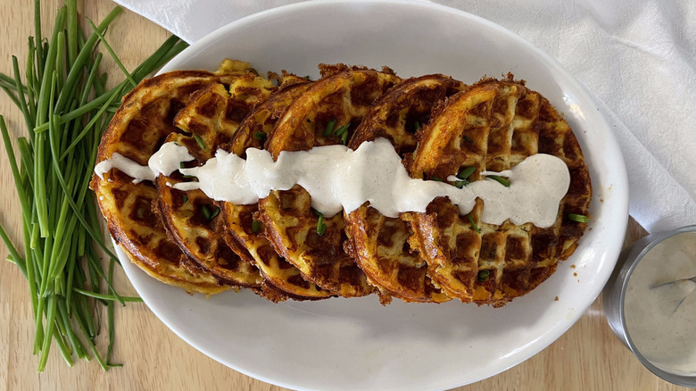 cheese waffles with sour cream and chive garnish