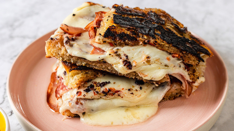 Side view of two slices of gooey, melty grilled cheese