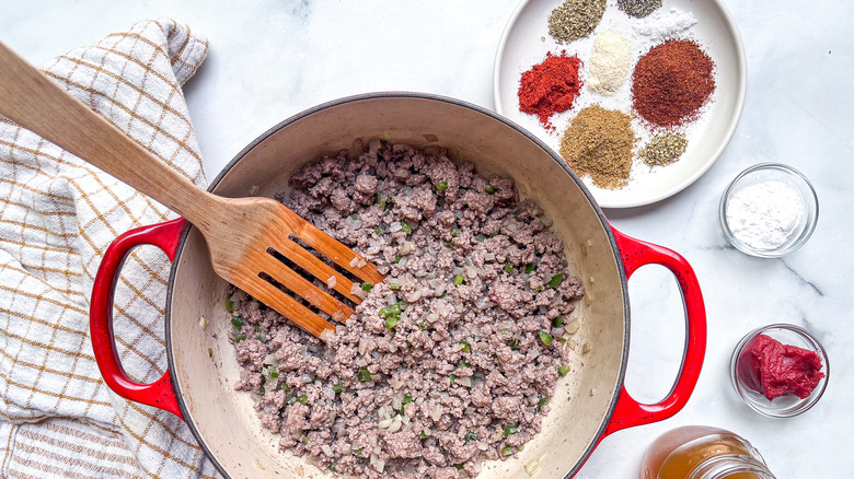 skillet with ground beef cooking