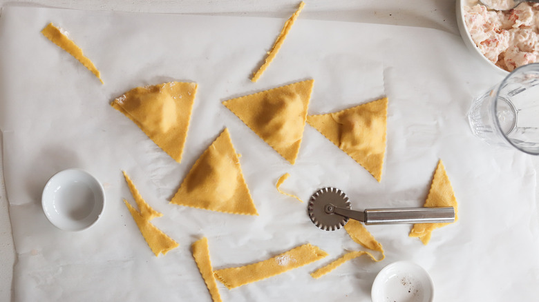 lobster ravioli in triangle shape with pastry cutter