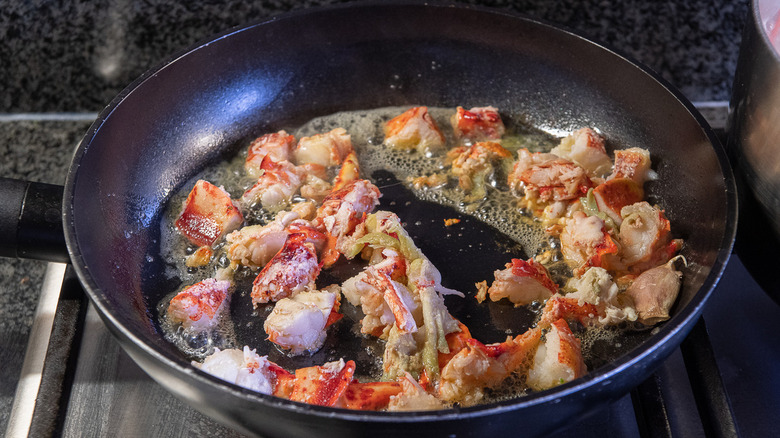 lobster pieces in frying pan