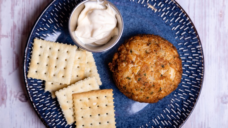 crab cake on plate with saltines