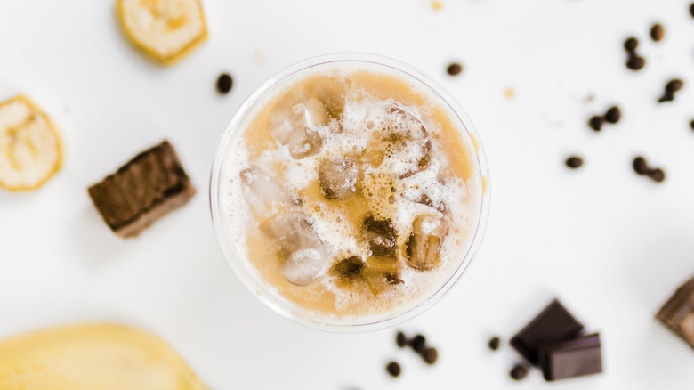 iced coffee with chocolate and banana in the background